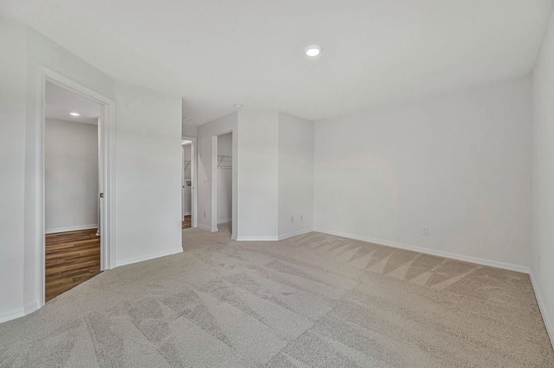 The spacious master bedroom with attached bathroom and walk-in closet
