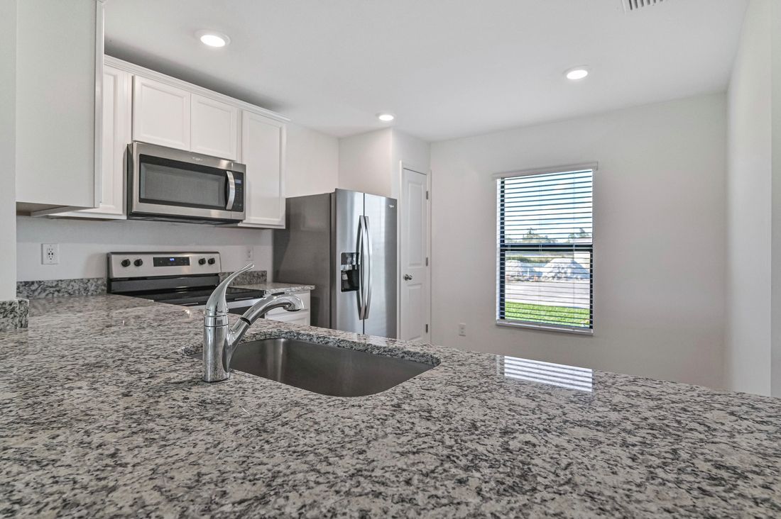 The kitchen is chef-ready with stainless steel appliances