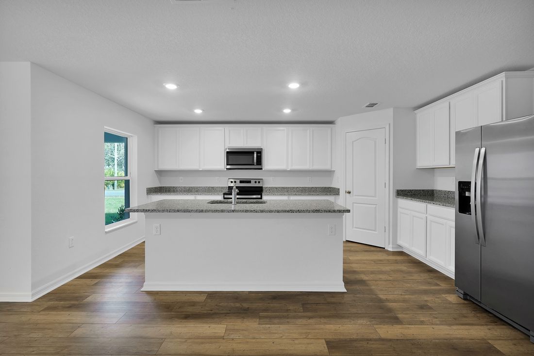 Overlooking the spacious family room, the sprawling granite countertops are sure to impress!