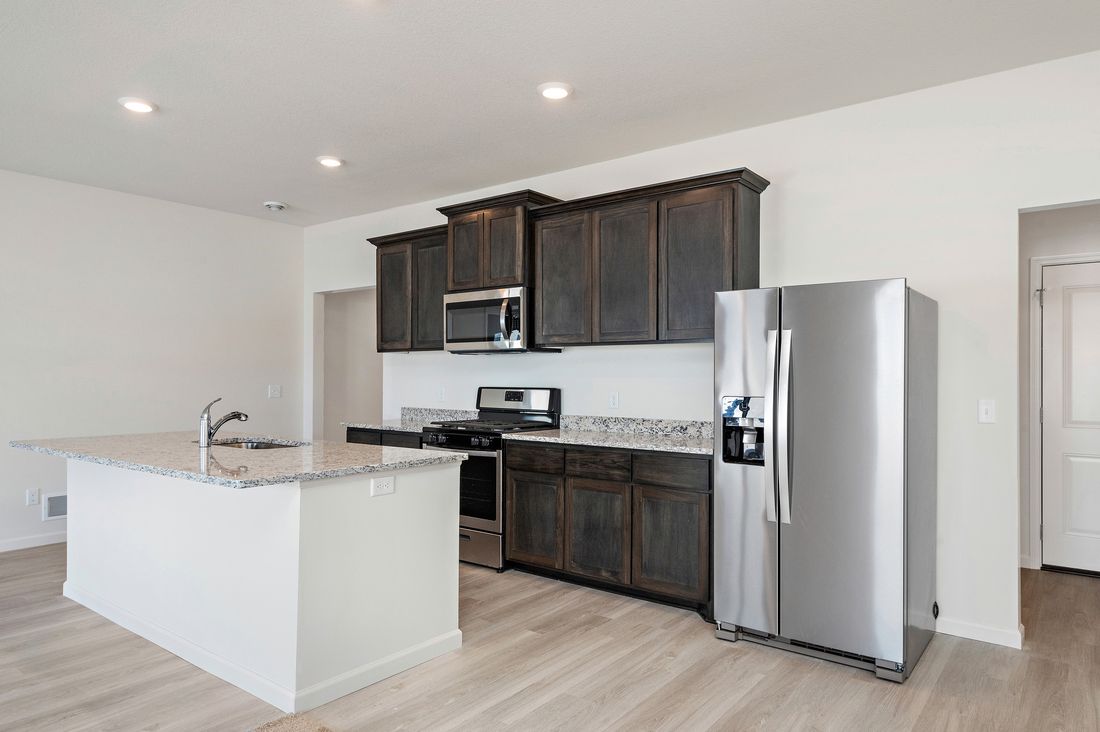 The kitchen is chef-ready with stainless steel appliances