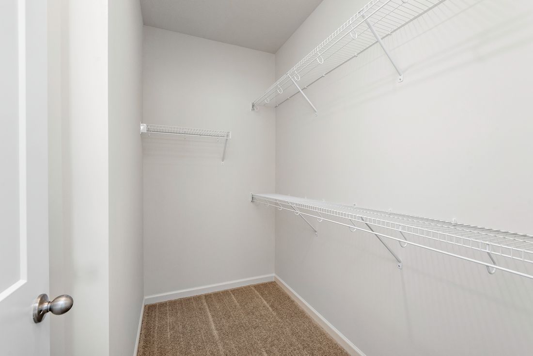 The walk-in closet is spacious and ready for your wardrobe