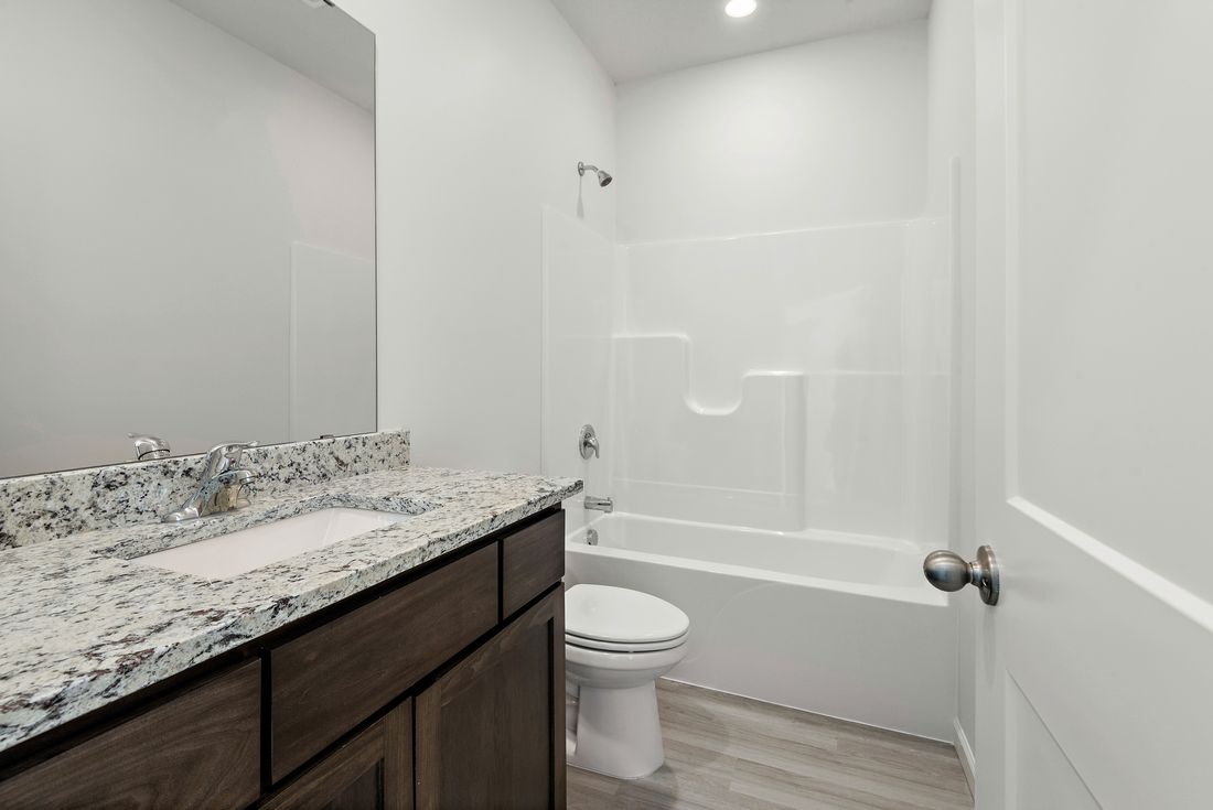 The guest bathroom has a spacious vanity and is ready for your guests