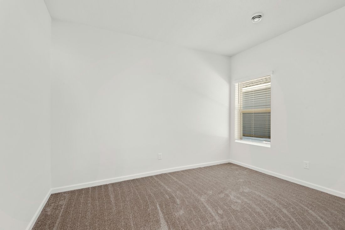 The guest bedroom is spacious and has plenty of natural light