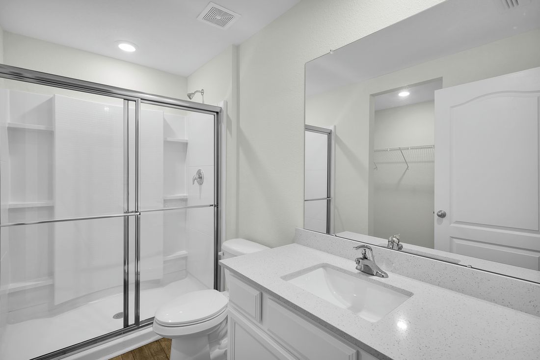 The master bathroom has a walk-in shower and spacious vanity