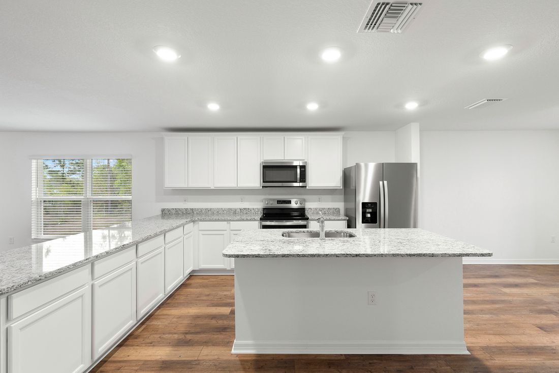 The kitchen has beautiful white cabinets