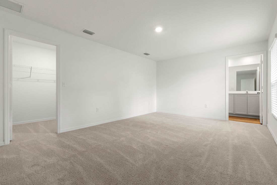 The master bedroom is spacious and has access to its own bathroom