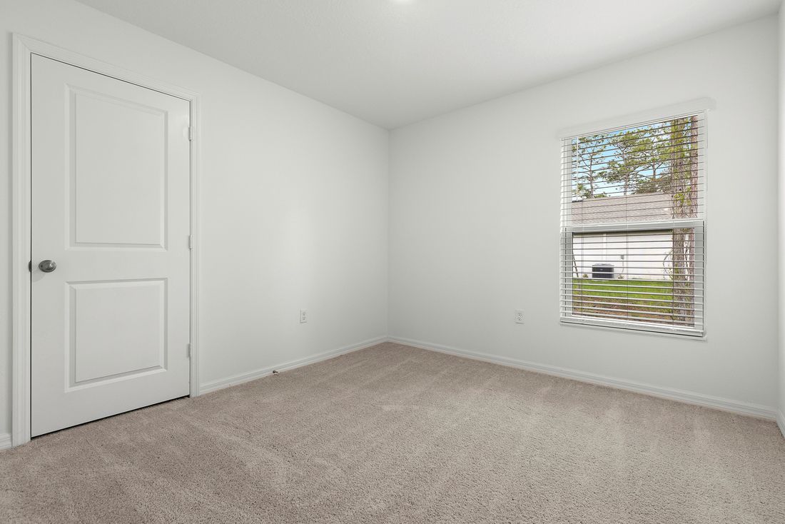 The guest bedroom is spacious with plenty of natural light
