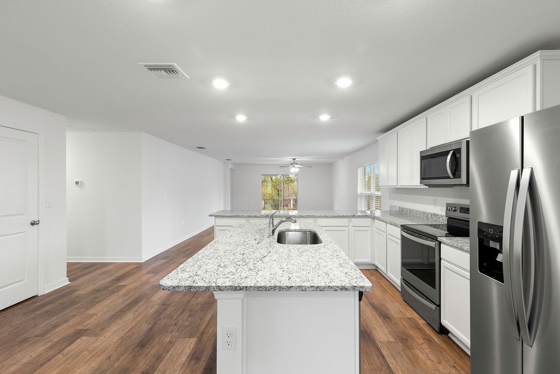 The kitchen is chef-ready with stainless steel appliances