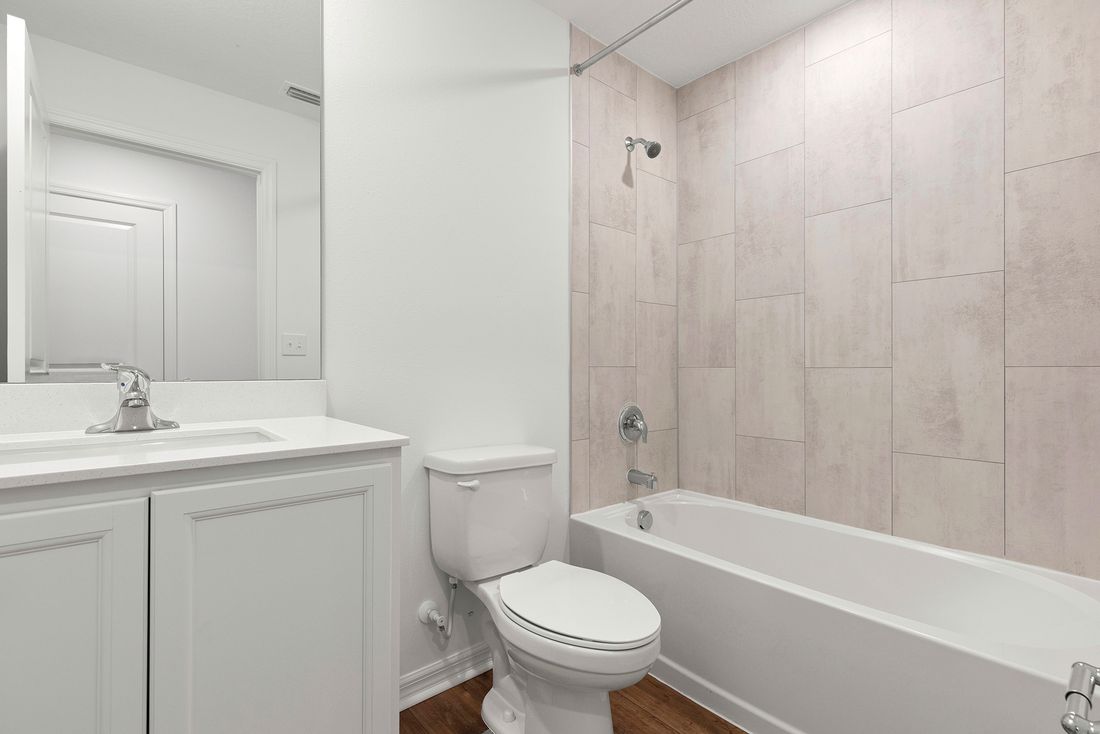 The guest bathroom has a beautifully tiled bathtub