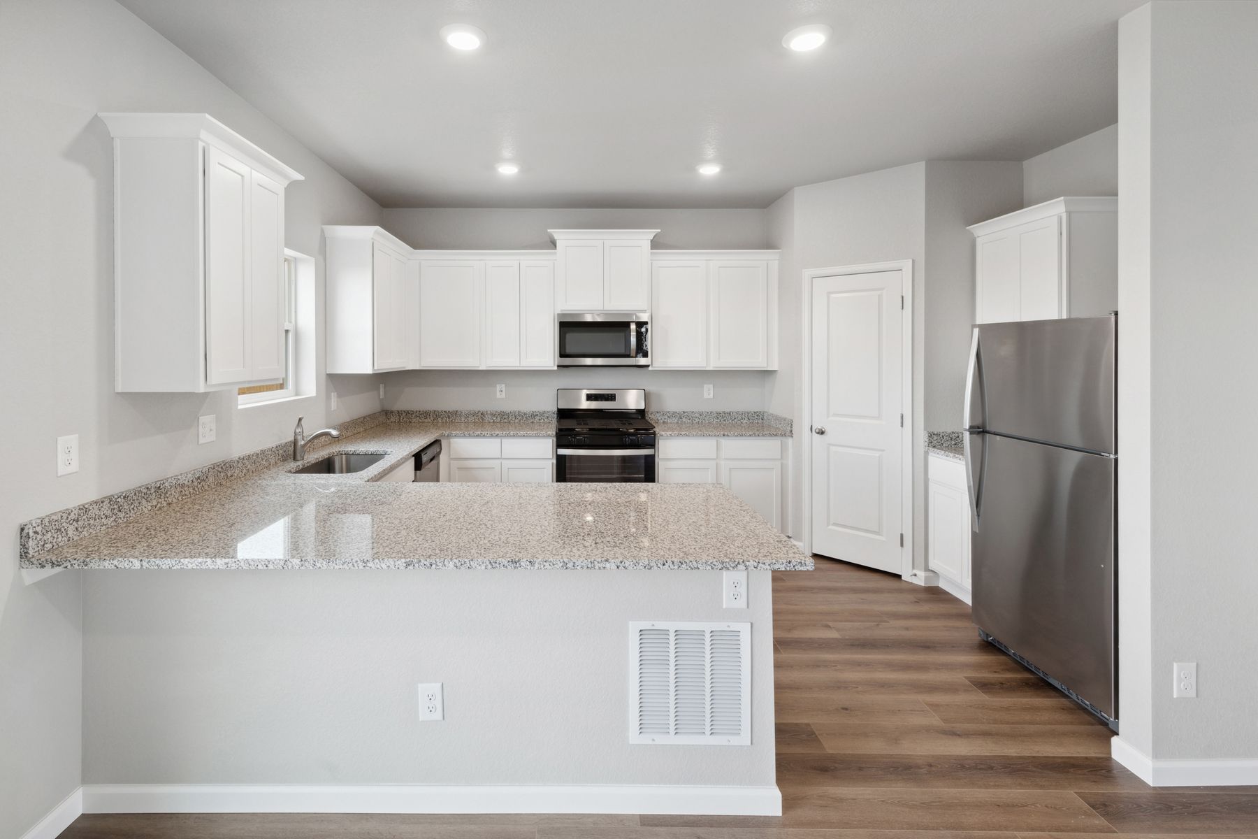 The kitchen of the Yale floor plan includes beautiful white cabinets, sprawling granite countertops, and energy-efficient appliances.