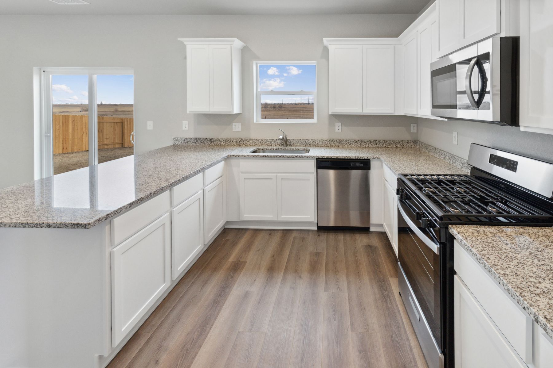 The kitchen of the Yale floor plan is surrounding by large windows for great natural lighting.