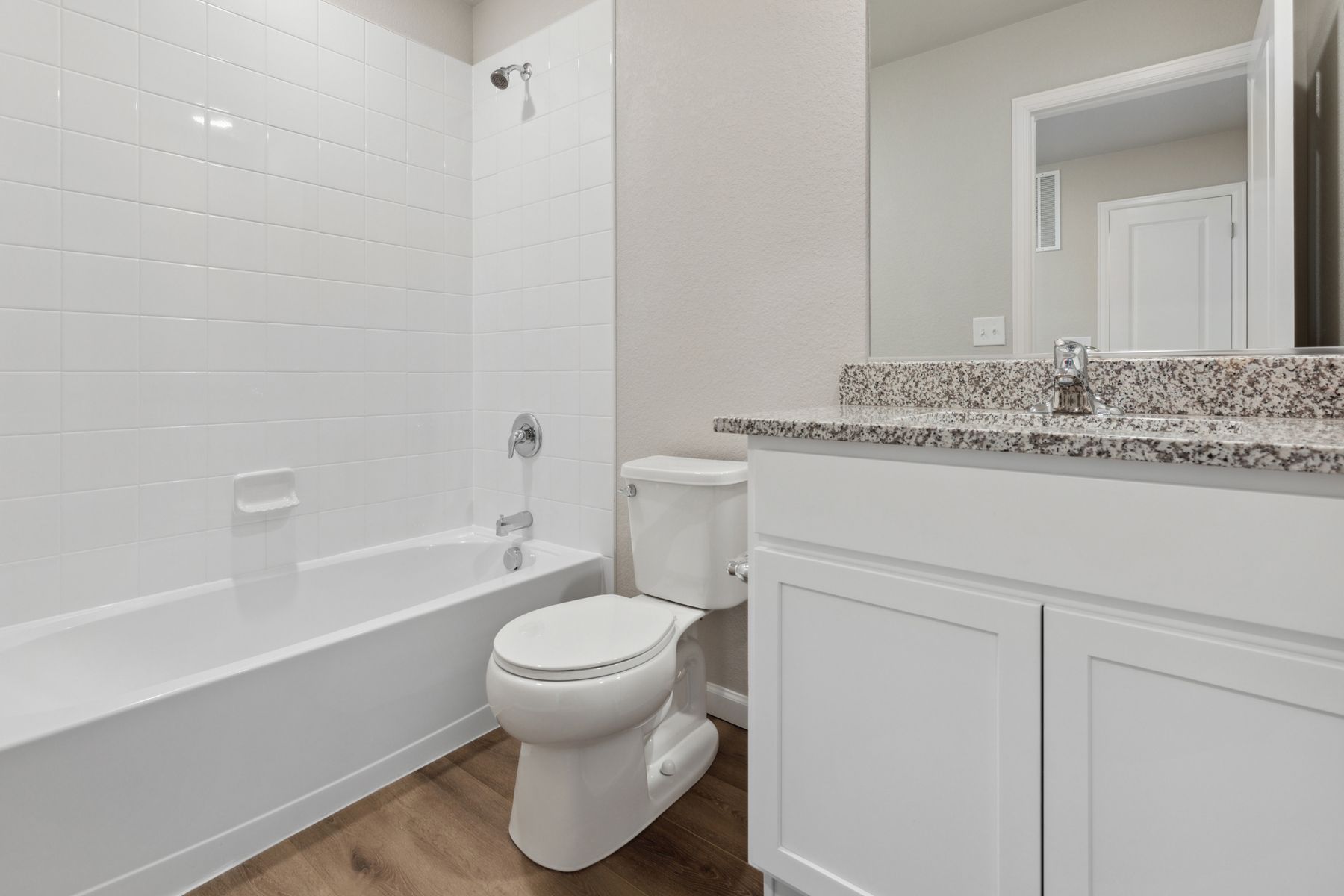 The secondary bathroom includes a shower-bathtub comination and a wonderful granite countertop vanity.