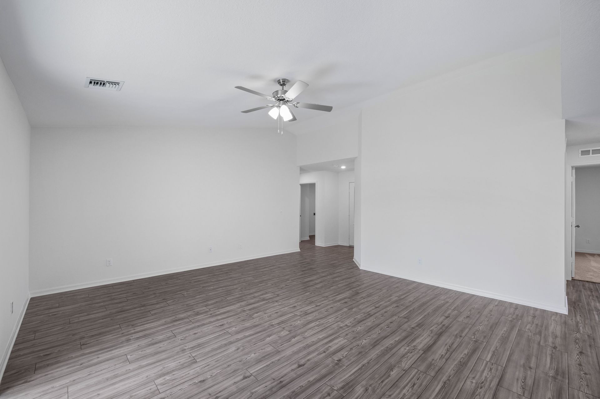 The family room is spacious and has a sliding door to the backyard
