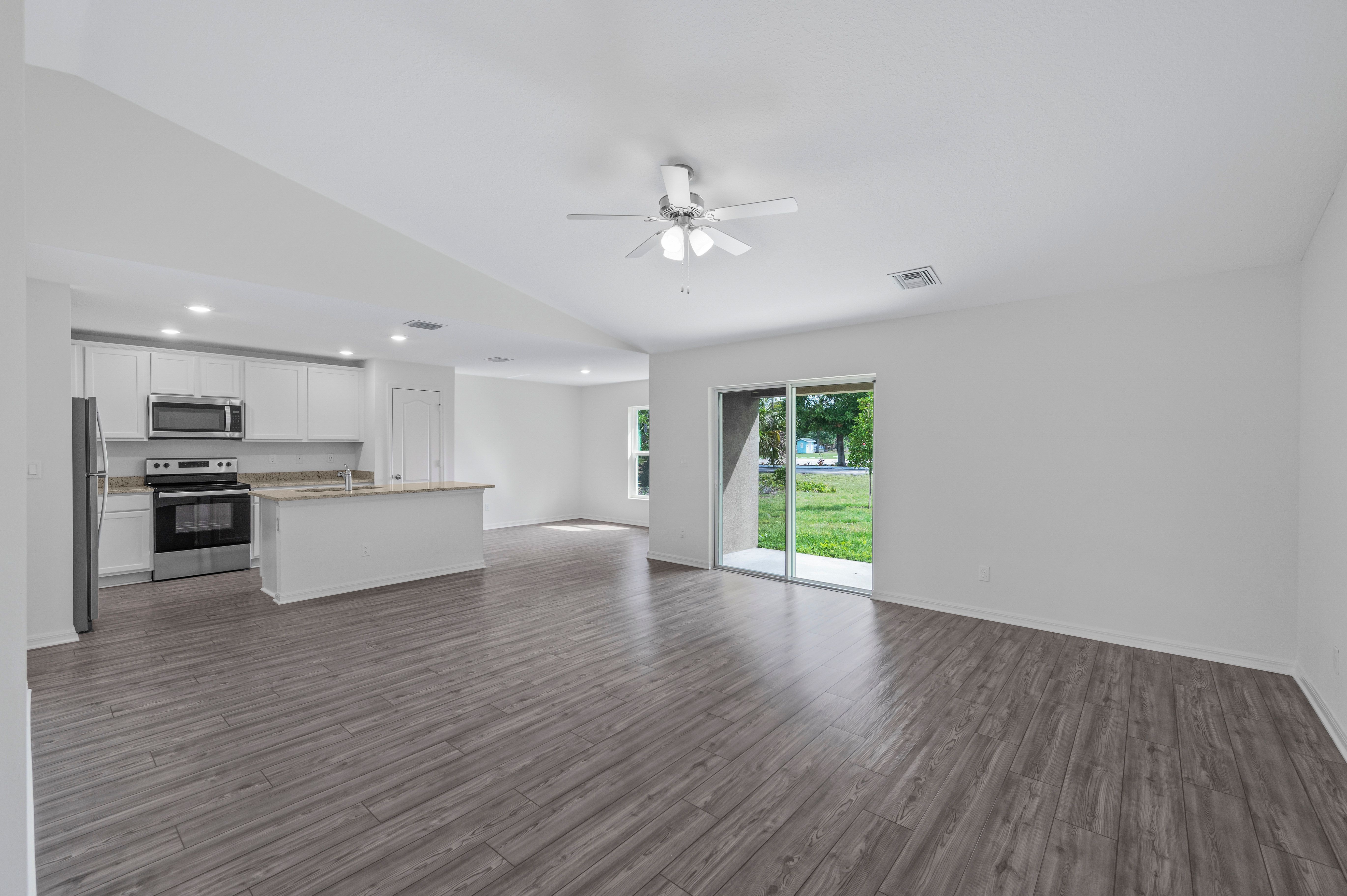The open concept entertainment space includes the living room, the dining room, and the kitchen