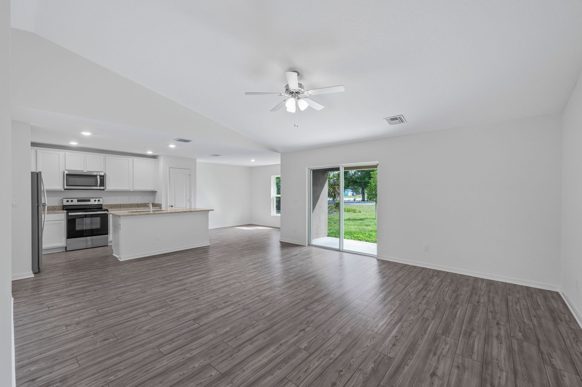 The open concept entertainment space includes the living room, the dining room, and the kitchen