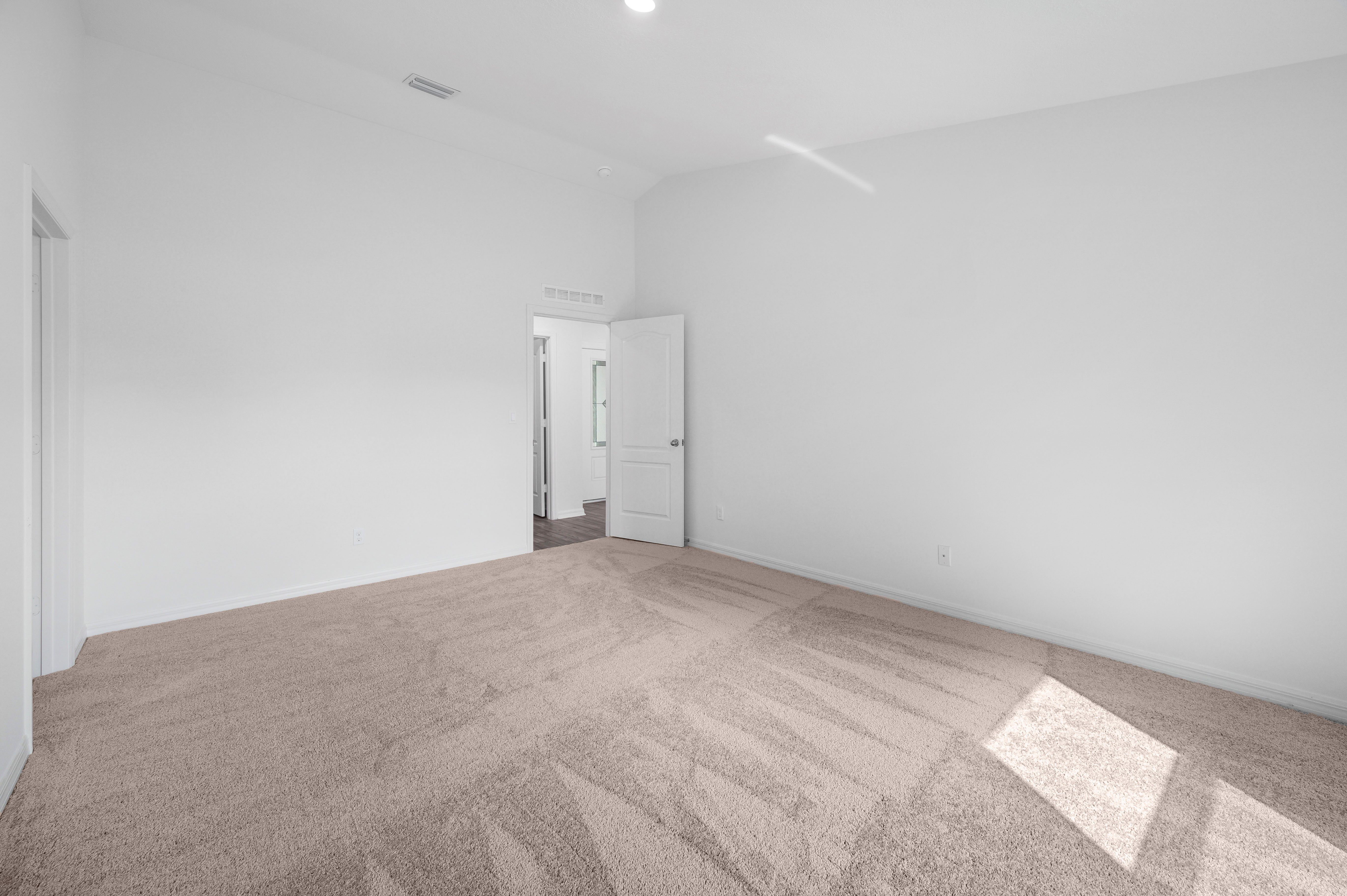 The master bedroom is spacious with access to its own bathroom