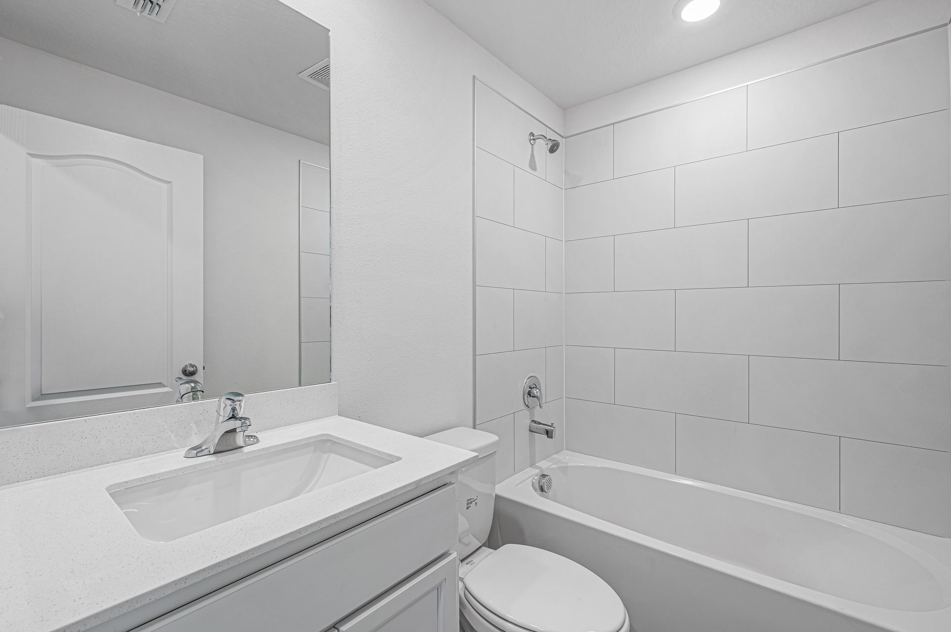 The spare bathroom has a large vanity and tub