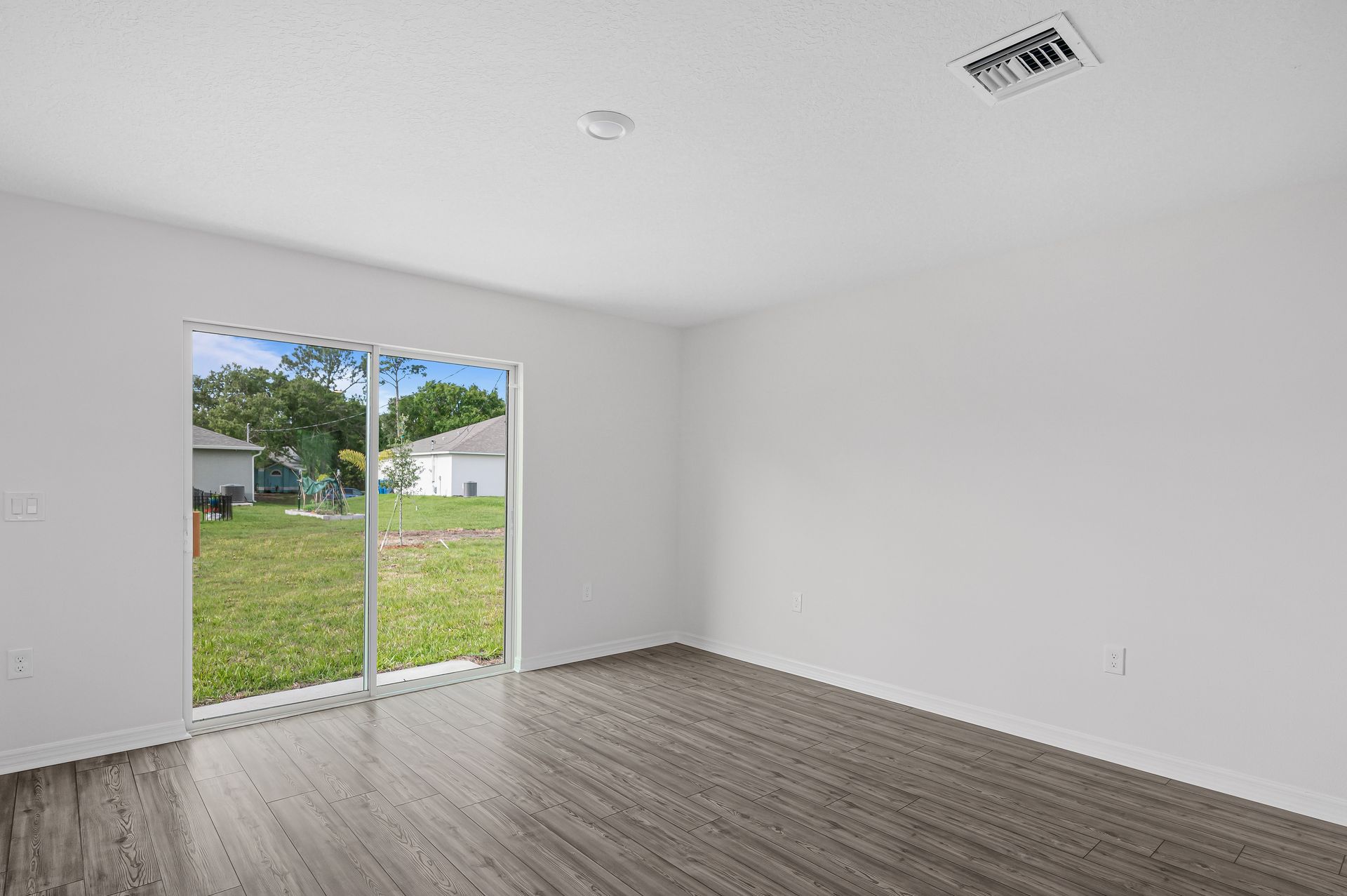 The family room is spacious and has a sliding glass door leading to the backyard