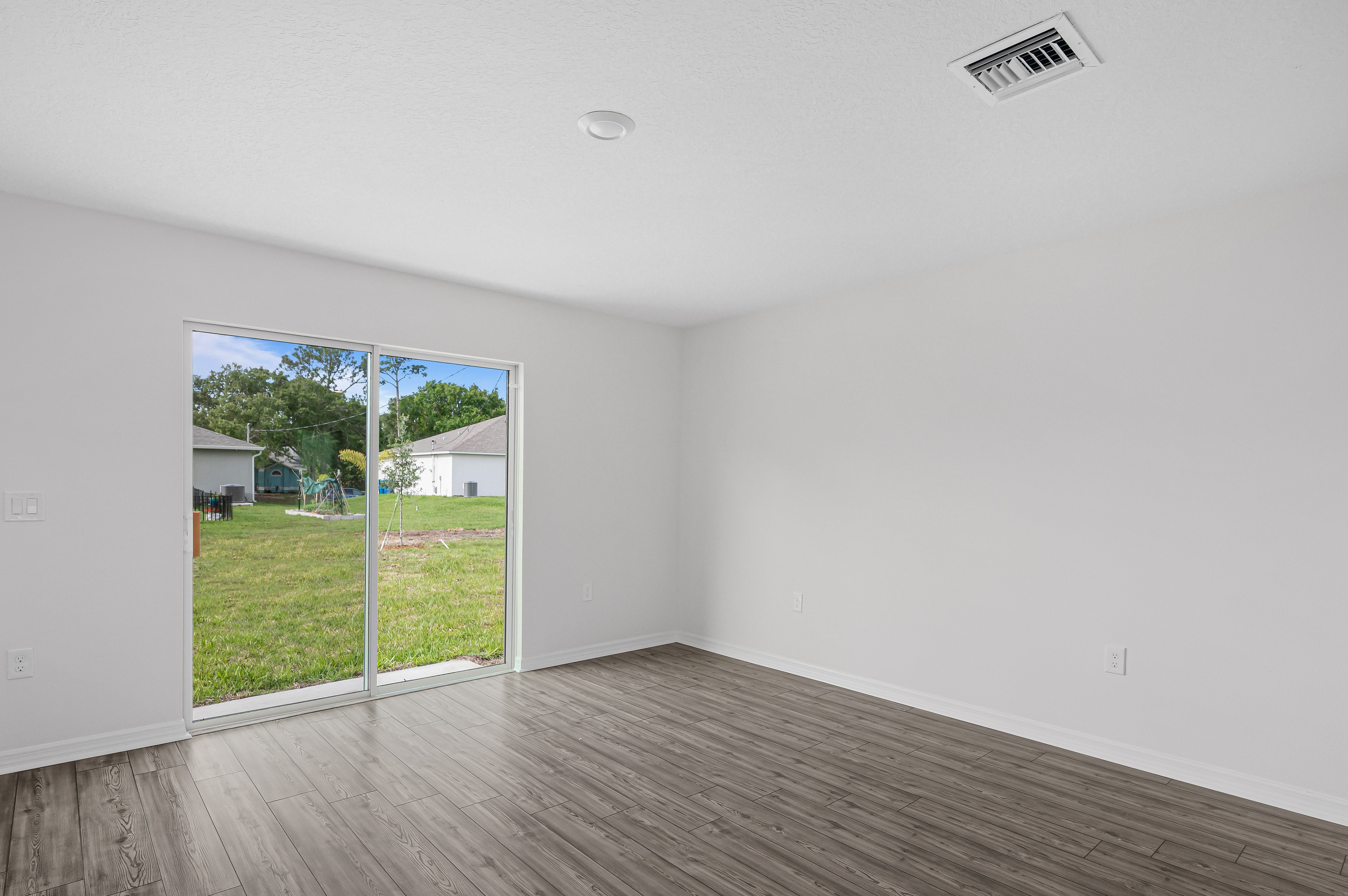 The family room is spacious and has a sliding glass door leading to the backyard