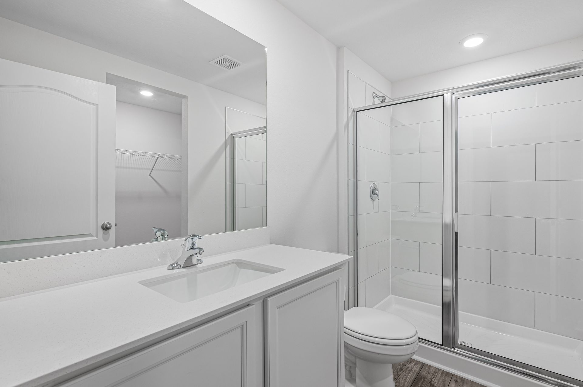 The master bathroom has a walk-in shower and spacious vanity