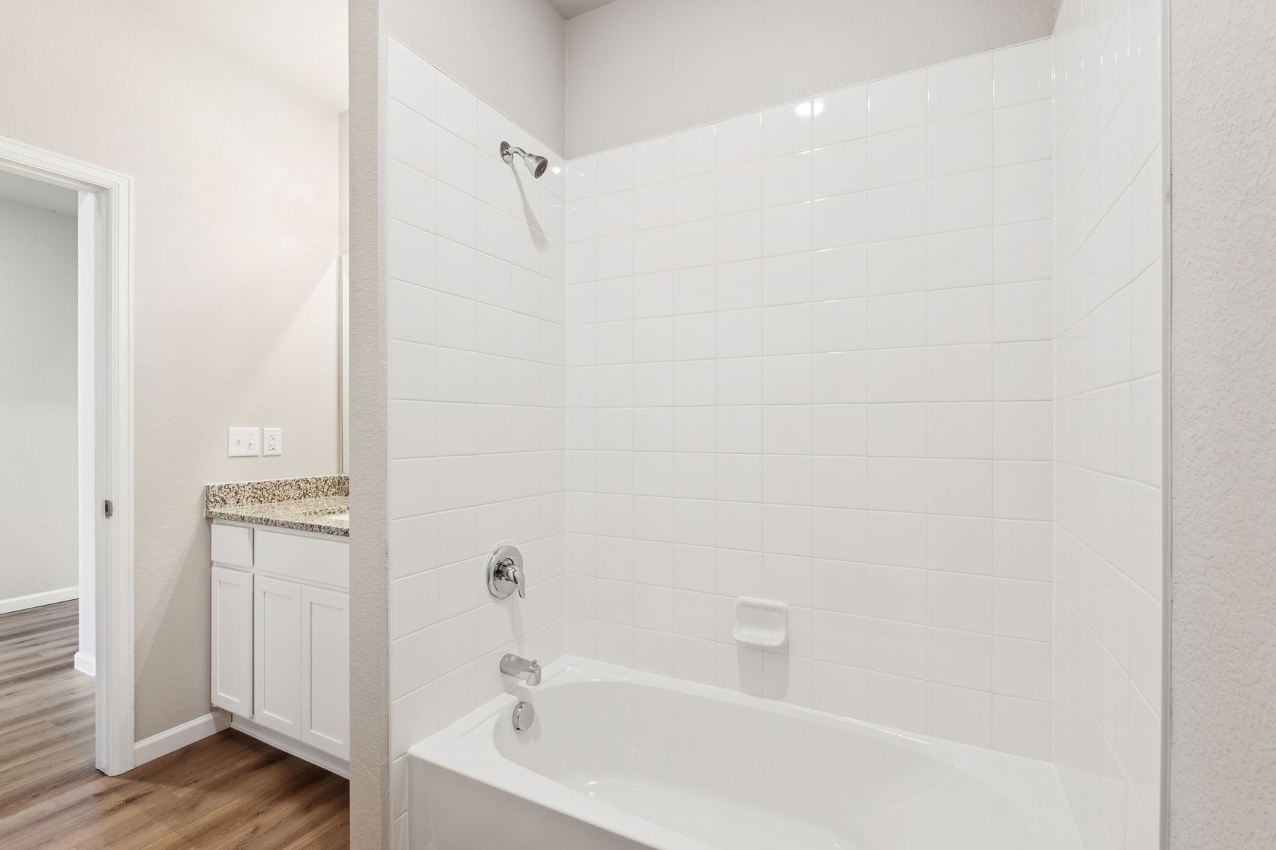 The secondary bathroom has a shower-tub combination.