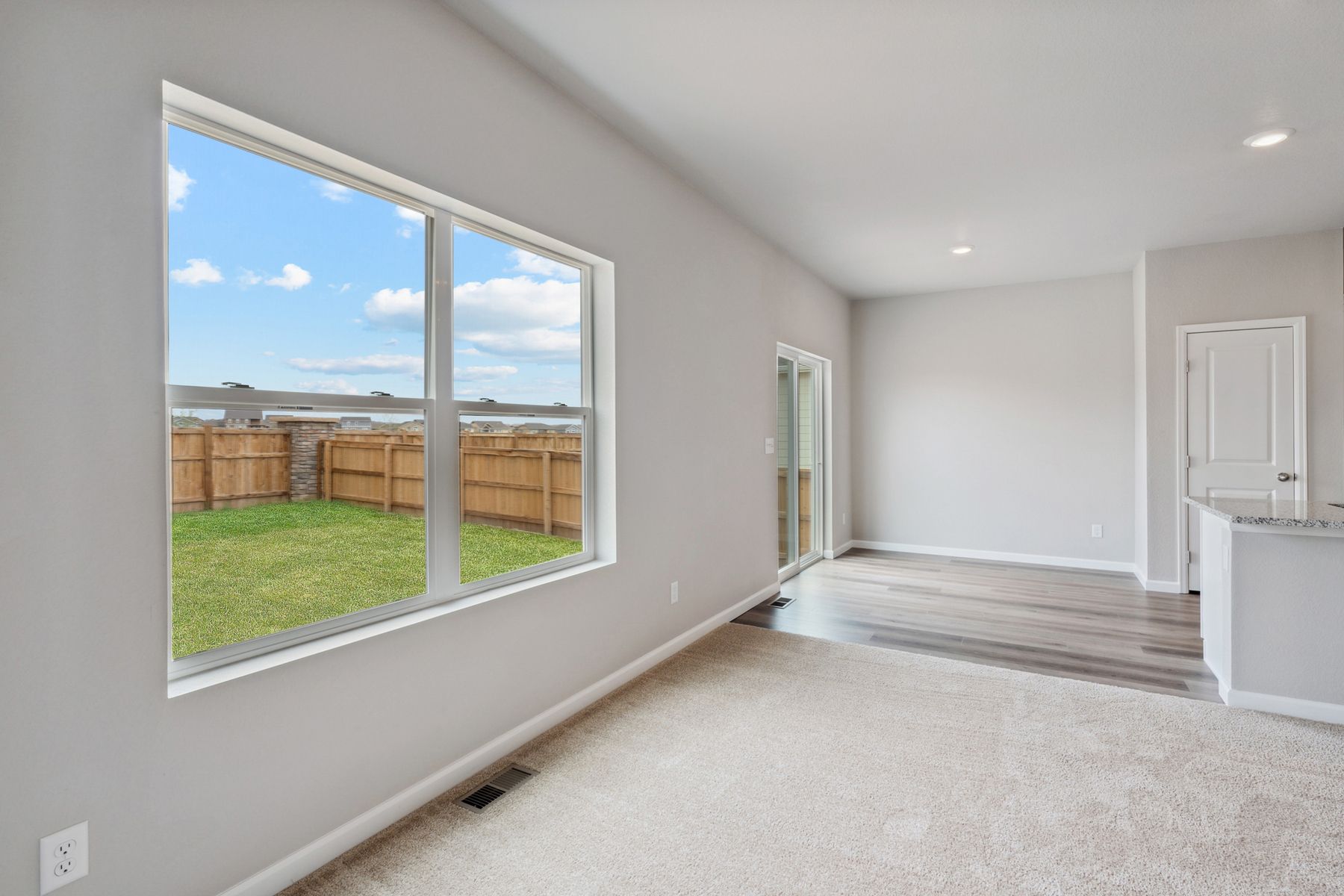 The family room, dining room, and kitchen have a great view of the fully-fenced back yard.