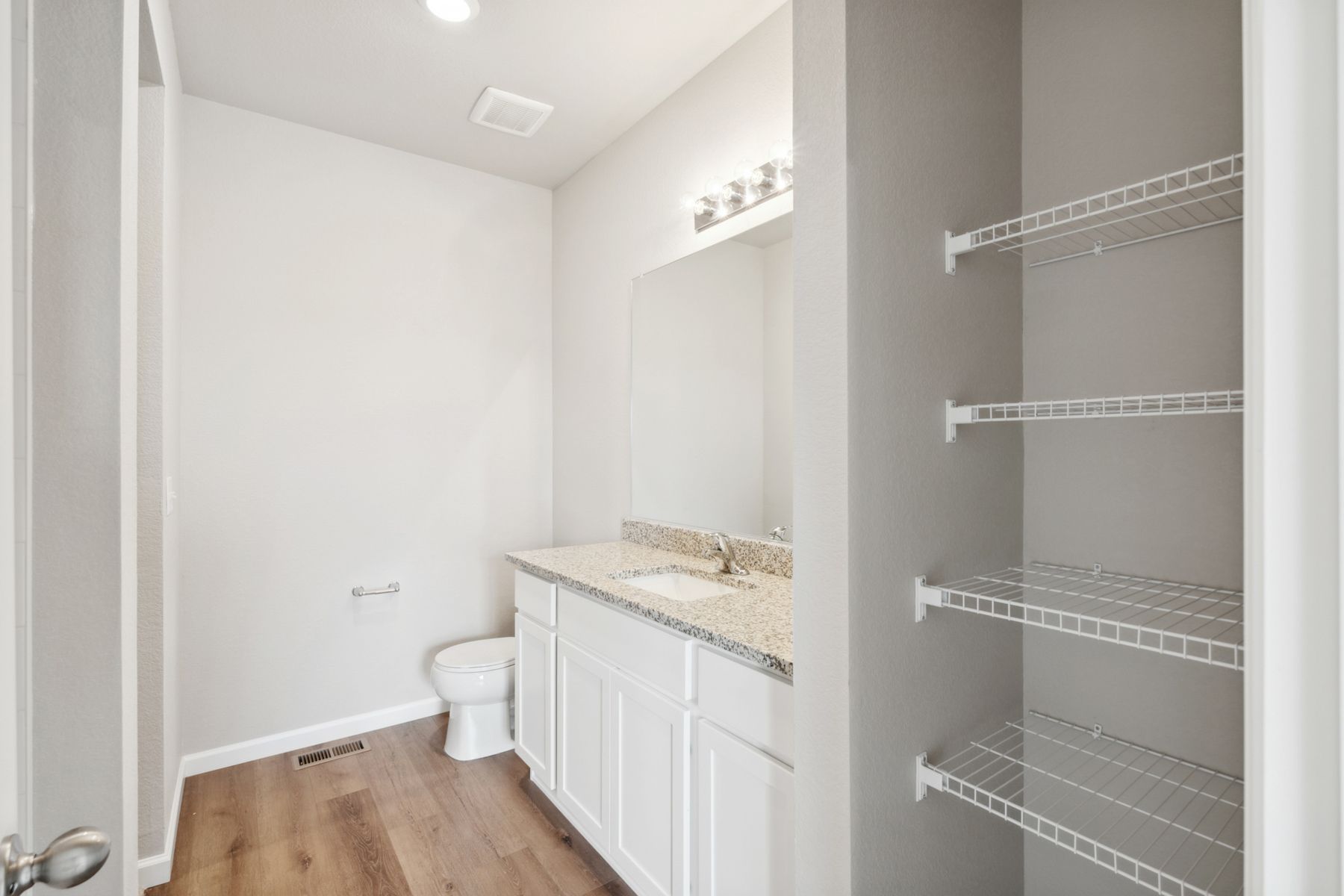 The master bathroom includes built-in shelves that are perfect for holding towels and other toiletry items.