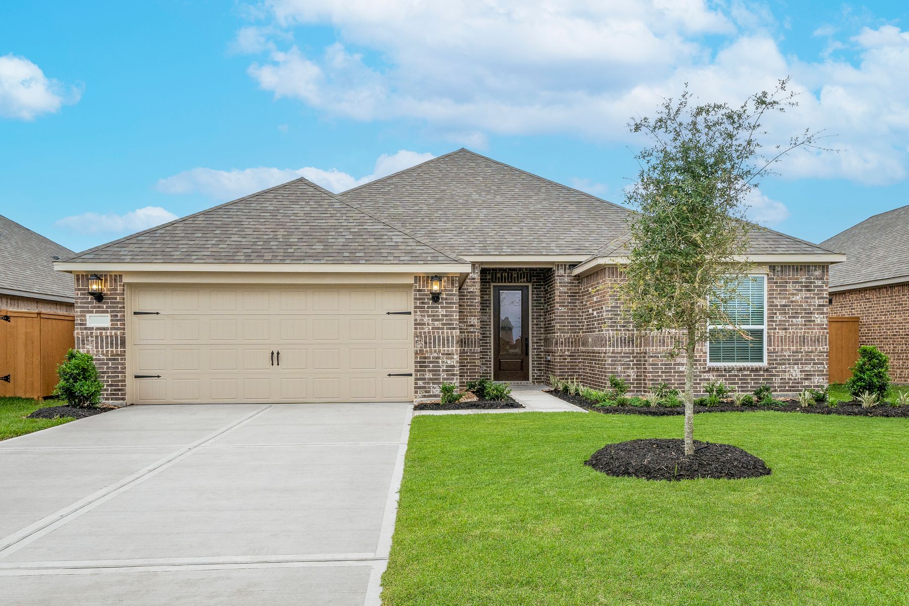 The Houghton is a single story home with brick and stone.