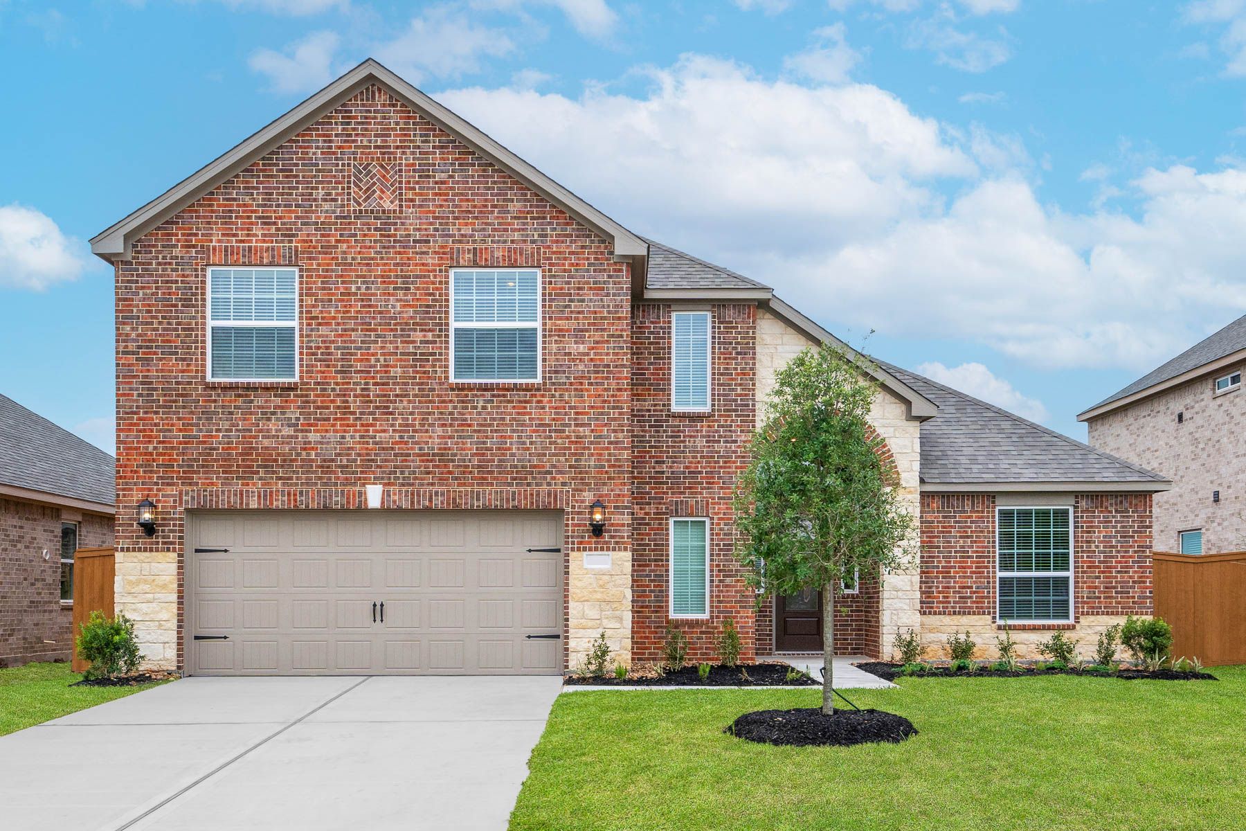 The Marquette is a two story home with brick.