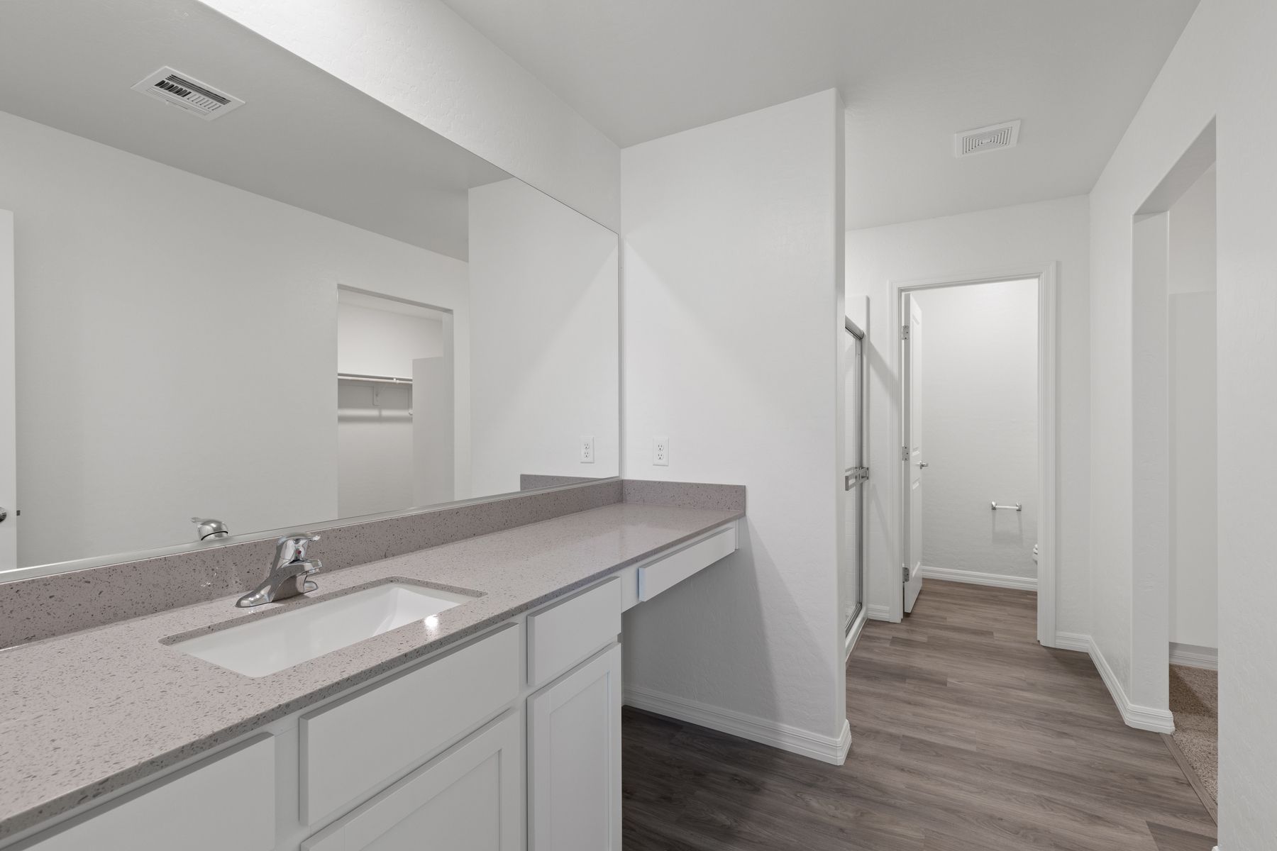 The master bathroom has a beautiful large vanity and a step in shower.