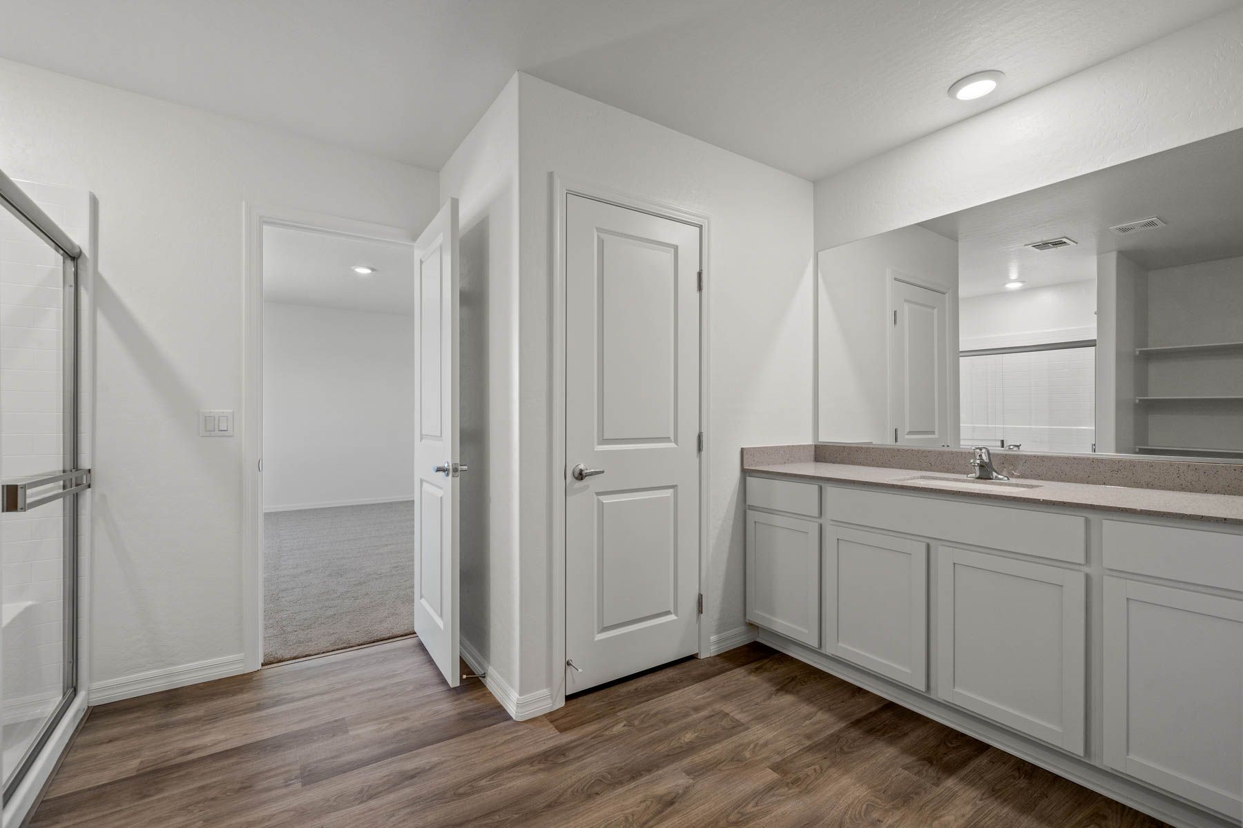 The master bathroom has a beautiful large vanity and a step in shower.