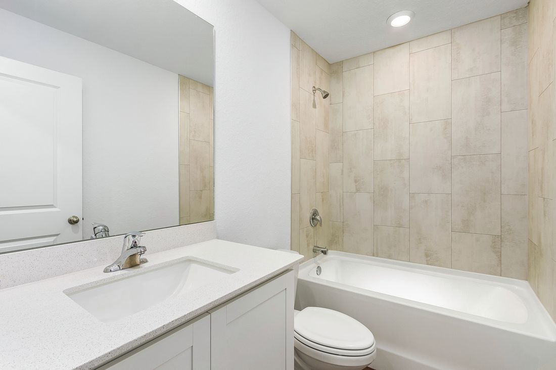 The guest bathroom has gorgeous tile in the shower
