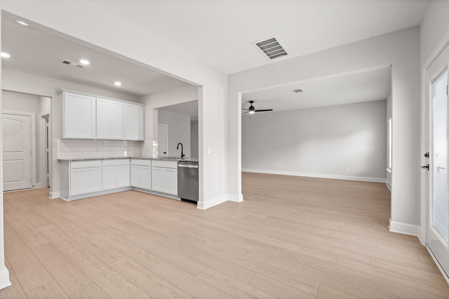 The kitchen of the Rayburn sits between the dining room and family room creating a functional, open-concept layout.