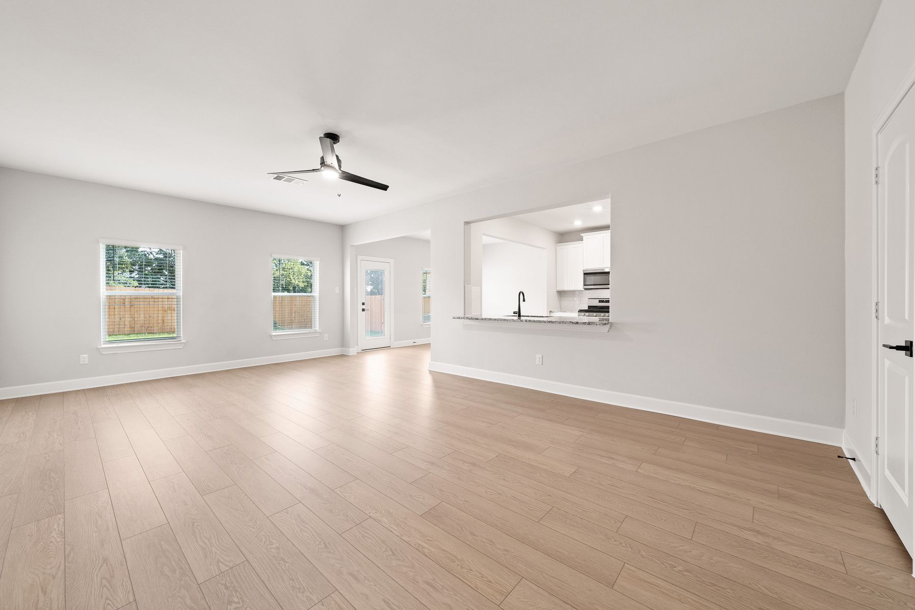 The family room of the Rayburn has two windows that create wonderful natural lighting.