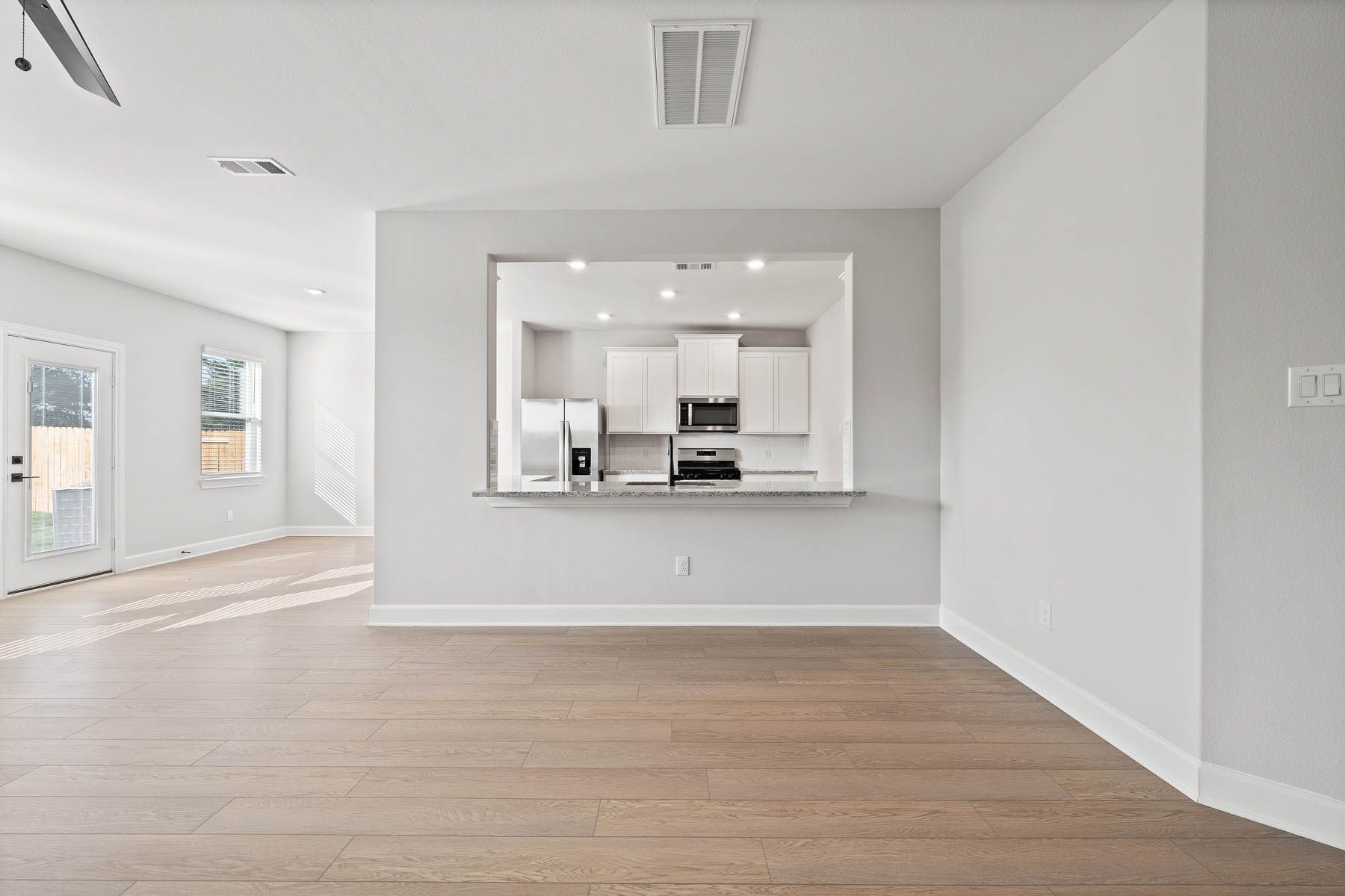 The kitchen of the Yaupon has beautiful white cabinets.