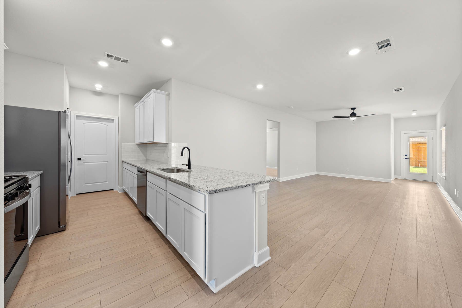 The family room of the Cedar sits right off of the kitchen.