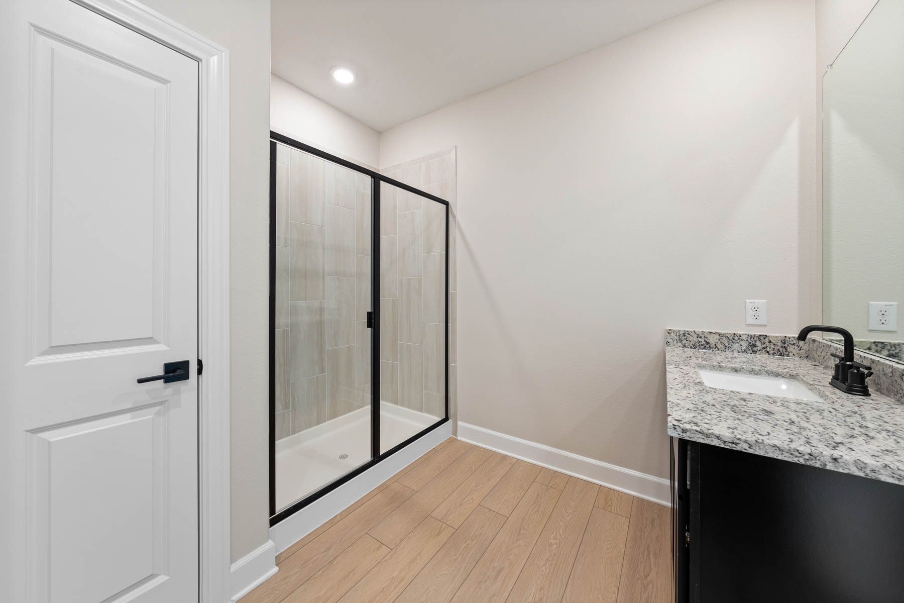 The master bathroom has a large vanity and beautiful walk-in, glass shower.
