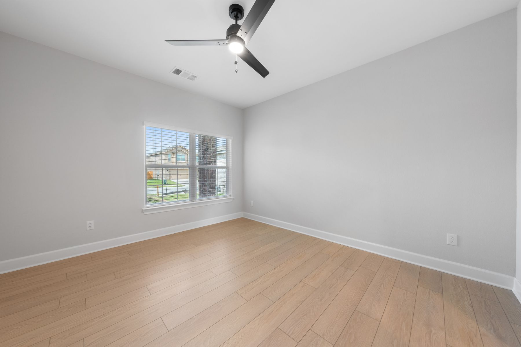 The master bedroom is large and has a window that allows in great natural light.