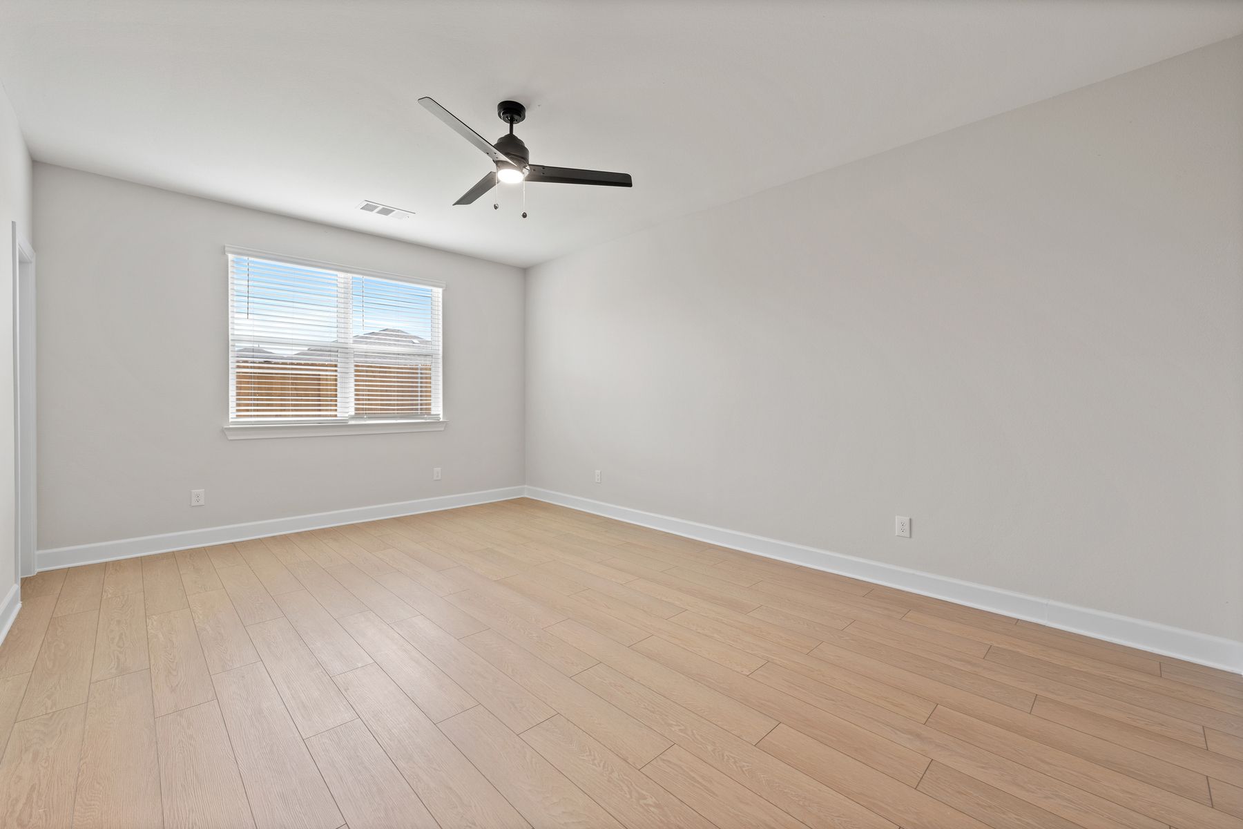 The master bedroom is large and has a window that lets in wonderful natural light.