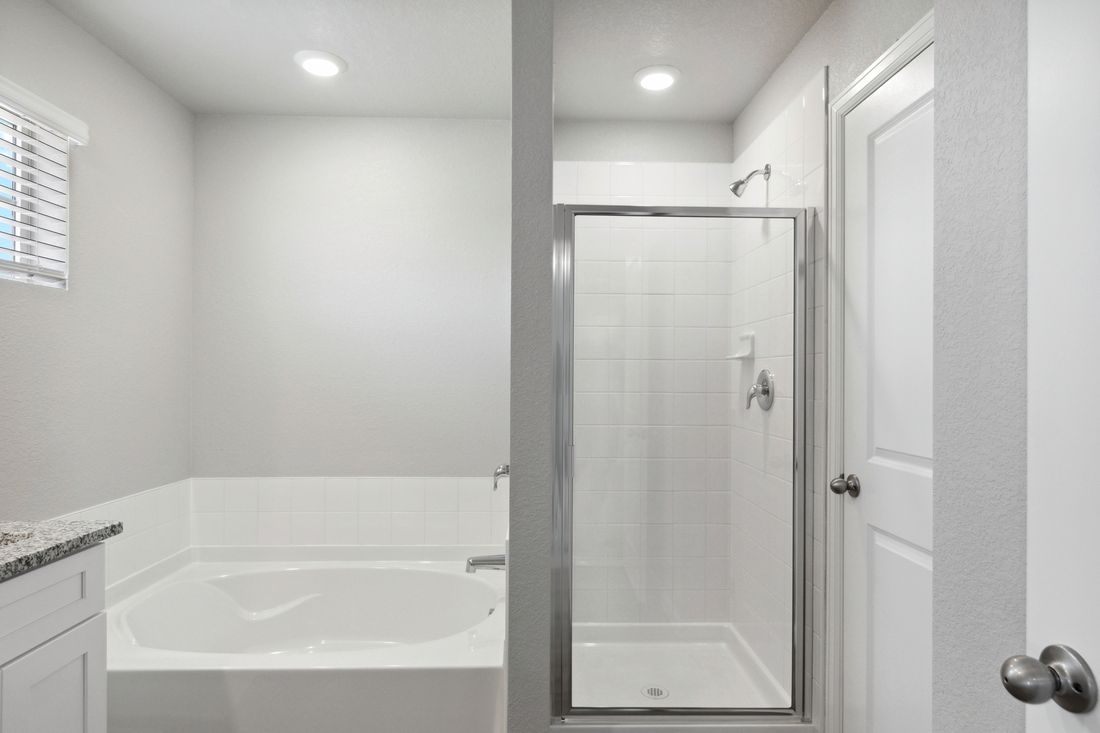 The master bathroom of the Platte has a garden tub and walk-in glass shower.