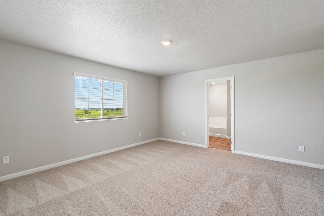 The master suite includes a large bedroom, private bathroom and walk-in closet.