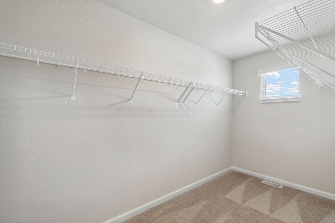 The walk-in, master closet is large and equipped to meet all of your storage needs.