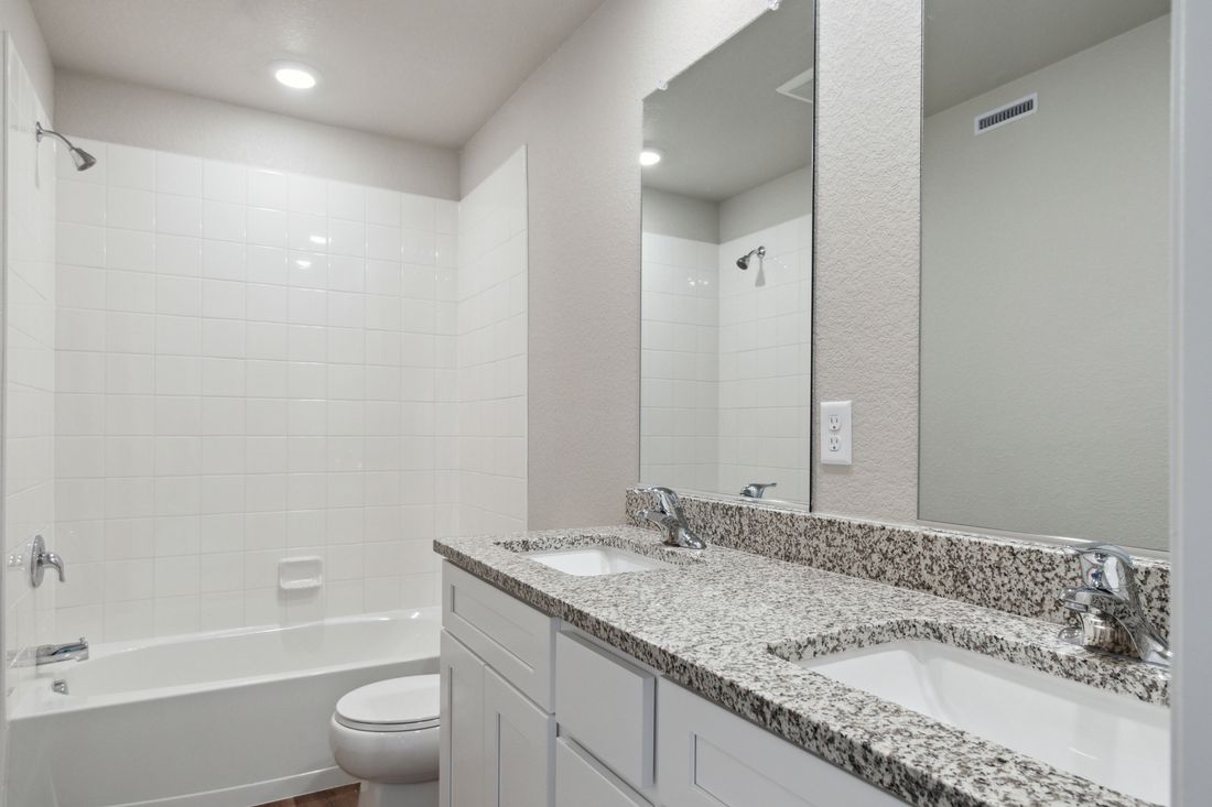 The secondary bathroom in the Platte has dual sinks and a shower-tub combo.