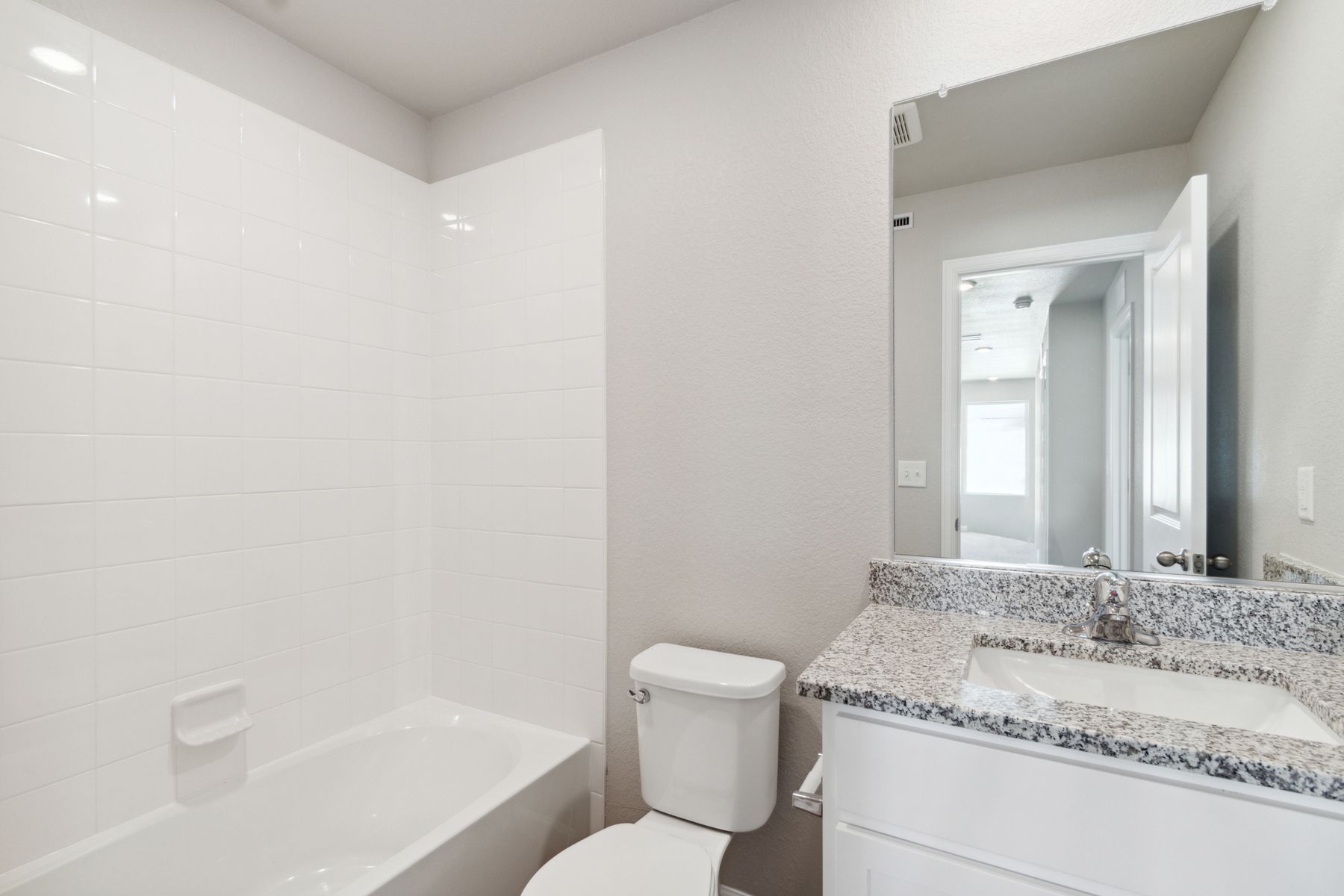 The secondary bathroom has a shower-tub combo.