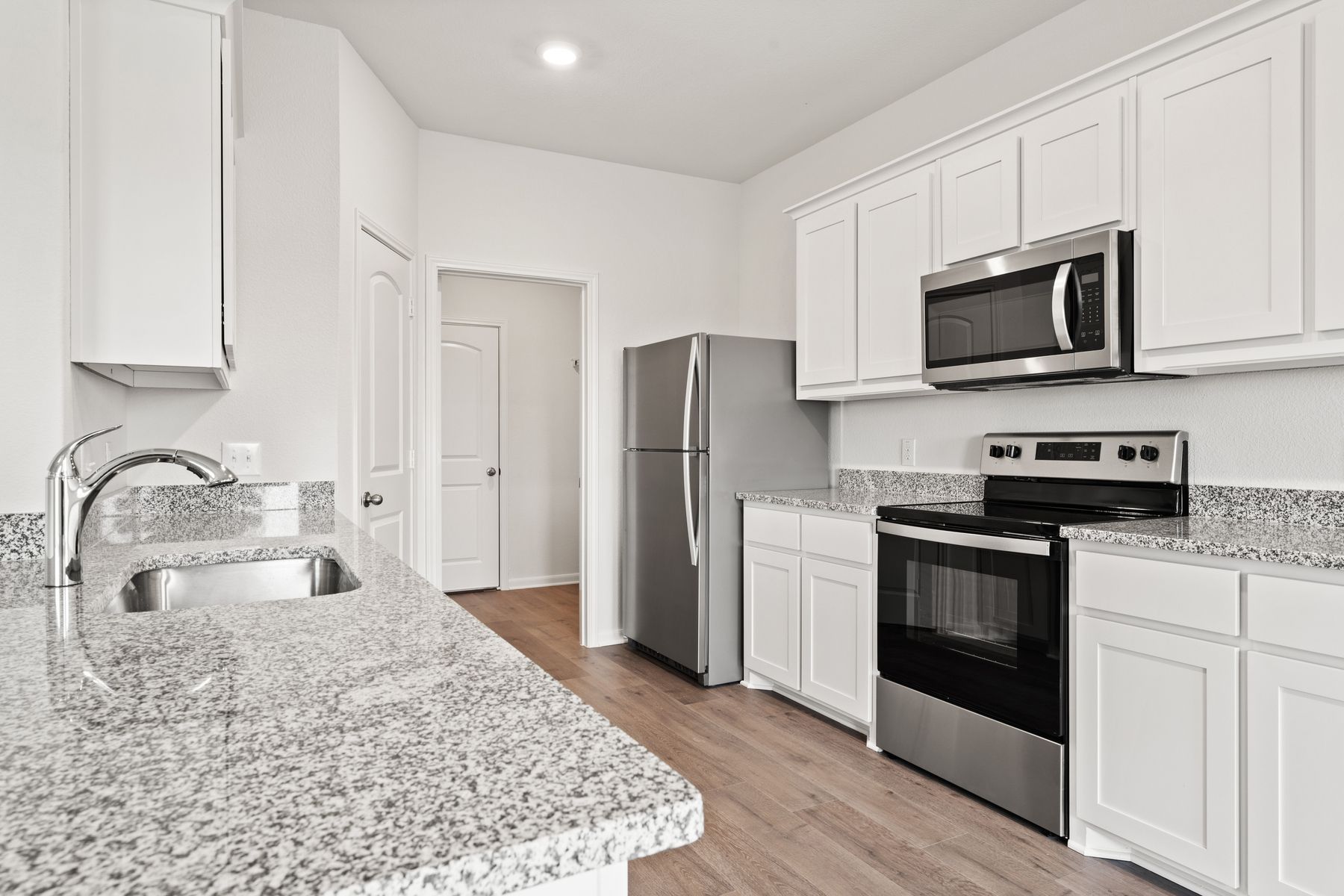 The kitchen of the Cypress has sprawling granite countertops.