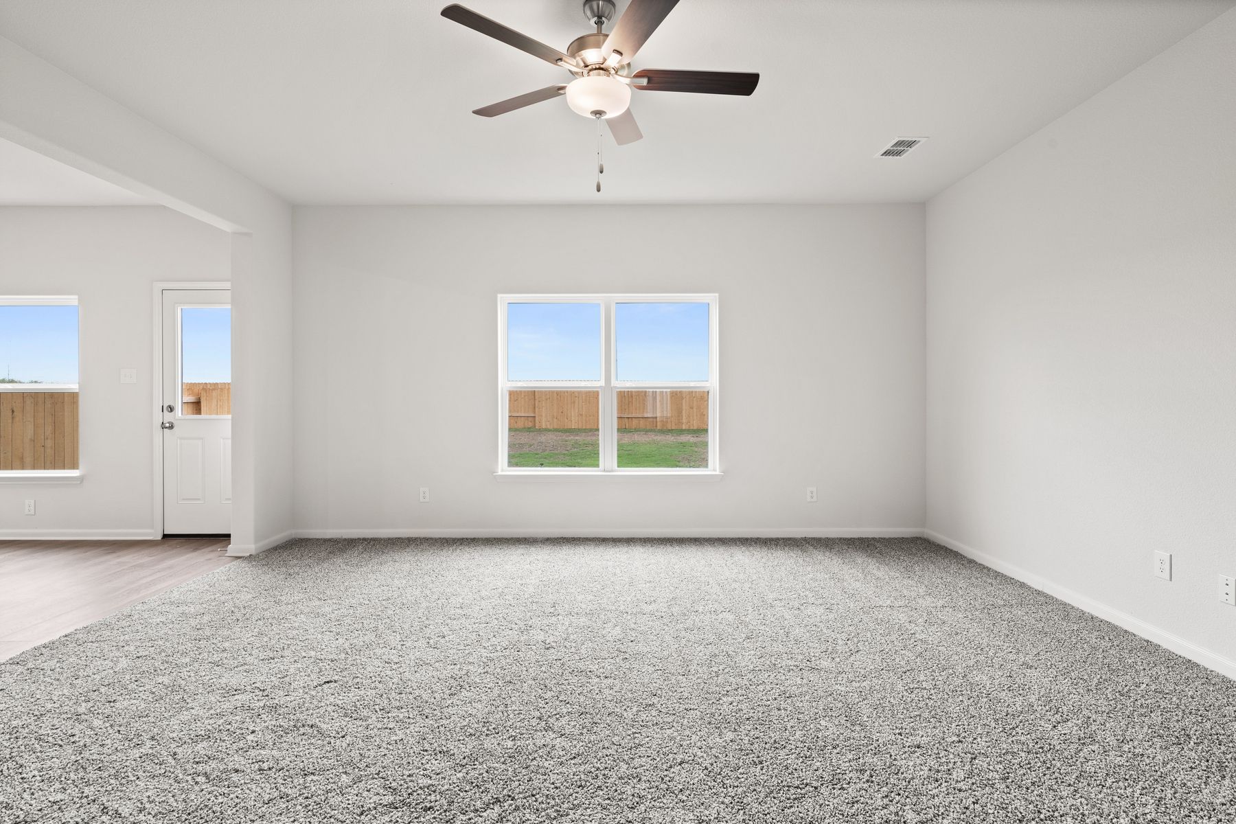 The family room of the Cypress has a large window with backyard views.