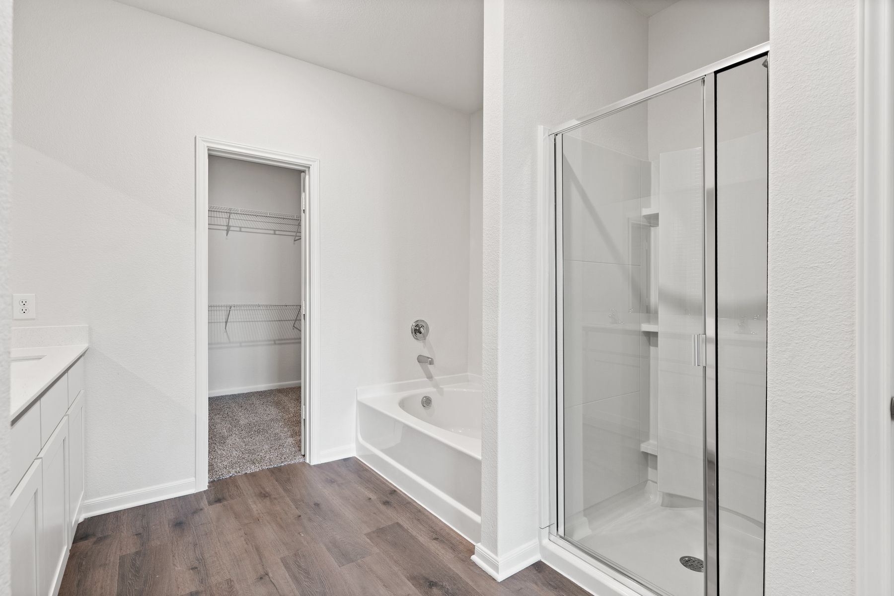 The master bathroom of the Cypress has a walk-in, glass shower and a large garden tub.