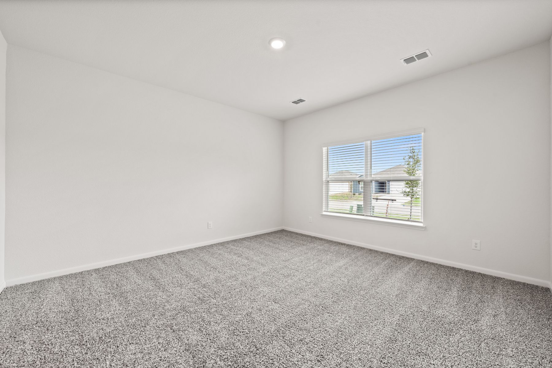 The master bedroom of the Cypress is large and has a window that lets in great, natural light.