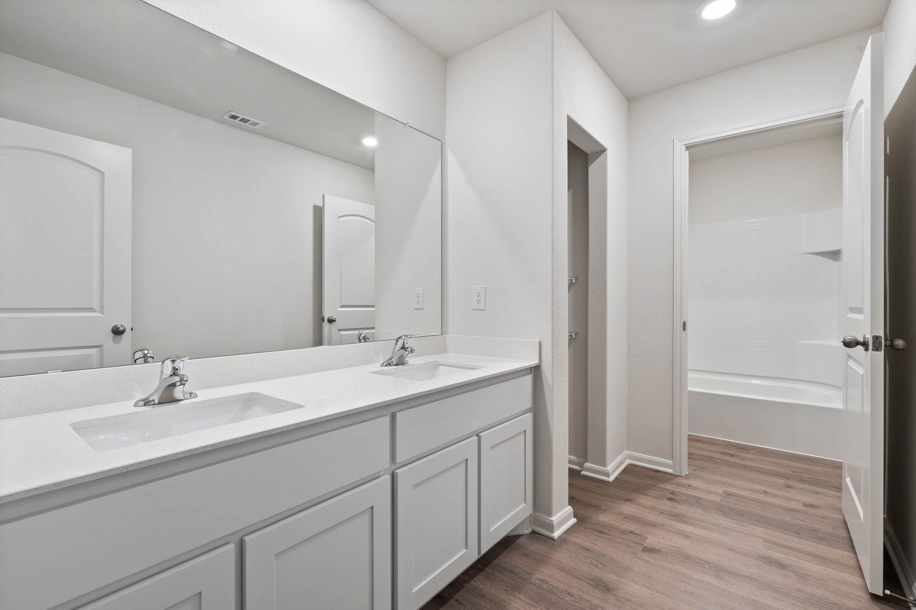 The secondary bathroom of the Driftwood has a large vanity with dual sinks.