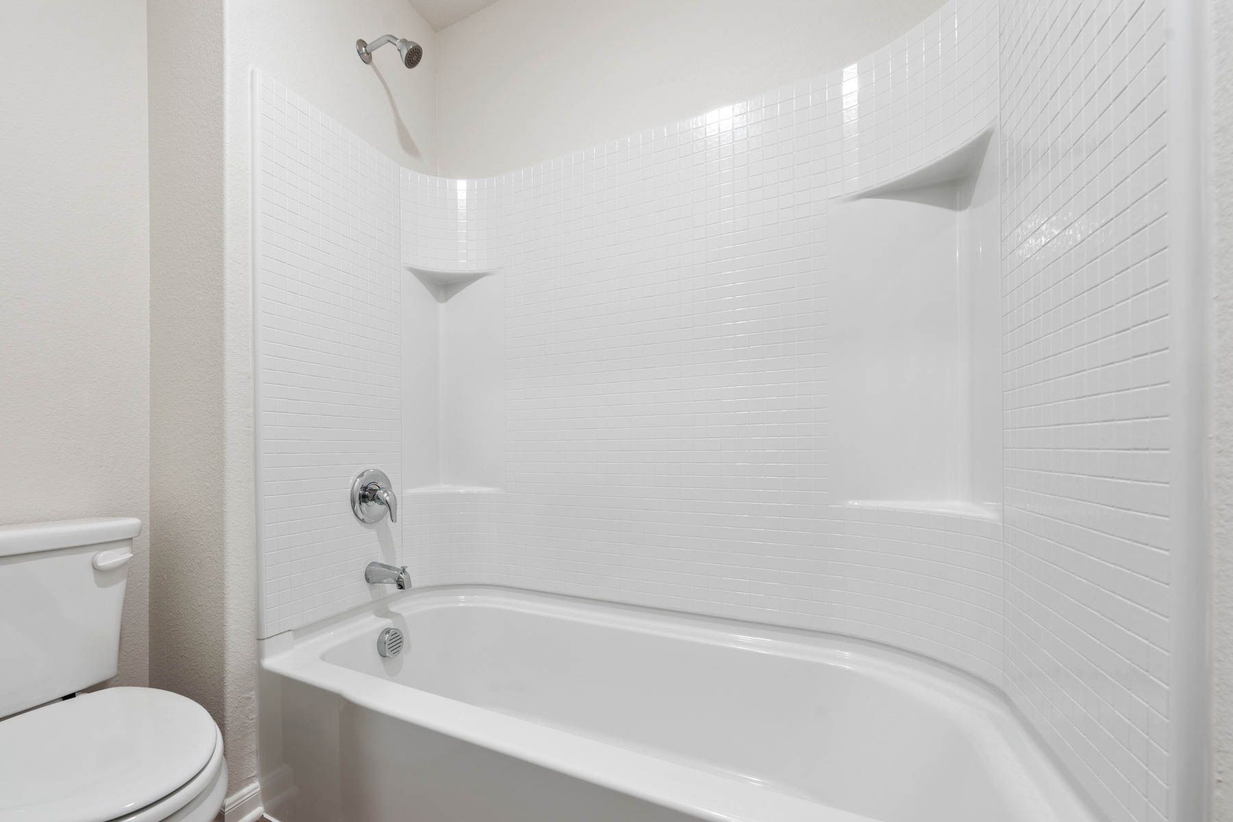 The secondary bathroom of the Driftwood has a shower-tub combo.